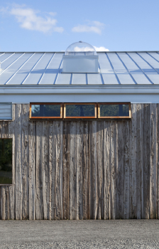 This photo shows the wood rainscreen siding. The rainscreen is made from reclaimed cypress lumber and eliminates the need for painting.